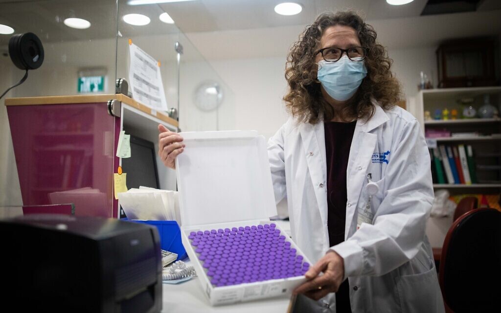 Estelle Bukatman, head of Pharmacy Services at Shaare Zedek Medical Center, holds coronavirus vaccine doses as they arrive in Jerusalem, on December 19, 2020. (Yonatan Sindel/Flash90)