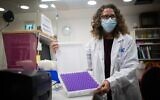 Estelle Bukatman, head of Pharmacy Services at Shaare Zedek Medical Center, holds coronavirus vaccine doses as they arrive in Jerusalem, on December 19, 2020. (Yonatan Sindel/Flash90)