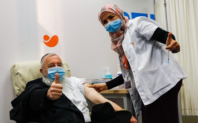 An Israeli citizen receives a COVID-19 vaccine, at a Meuhedet vaccination center in Jerusalem, on December 21, 2020. (Olivier Fitoussi/Flash90) An Israeli citizen receives a COVID-19 vaccine, at a Meuhedet vaccination center in Jerusalem, on December 21, 2020. (Olivier Fitoussi/Flash90)