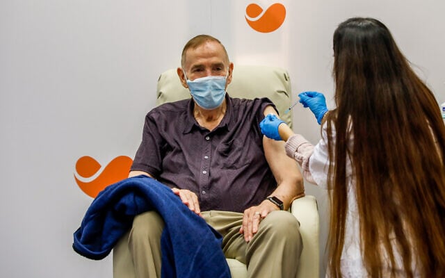An Israeli citizen receives a COVID-19 vaccine, at a Meuhedet vaccination center in Jerusalem, on December 21, 2020. (Olivier Fitoussi/Flash90) An Israeli citizen receives a COVID-19 vaccine, at a Meuhedet vaccination center in Jerusalem, on December 21, 2020. (Olivier Fitoussi/Flash90)