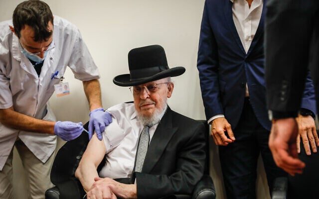 An Israeli citizen receives a COVID-19 vaccine, at a Meuhedet vaccination center in Jerusalem, on December 21, 2020. (Olivier Fitoussi/Flash90) An Israeli citizen receives a COVID-19 vaccine, at a Meuhedet vaccination center in Jerusalem, on December 21, 2020. (Olivier Fitoussi/Flash90)