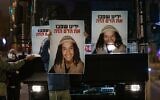 Demonstrators holds placards showing Ahuvia Sandak as they protest against his death in a car crash during a police chase, outside the national police headquarters in Jerusalem, on December 26, 2020. (Yonatan Sindel/ Flash90)