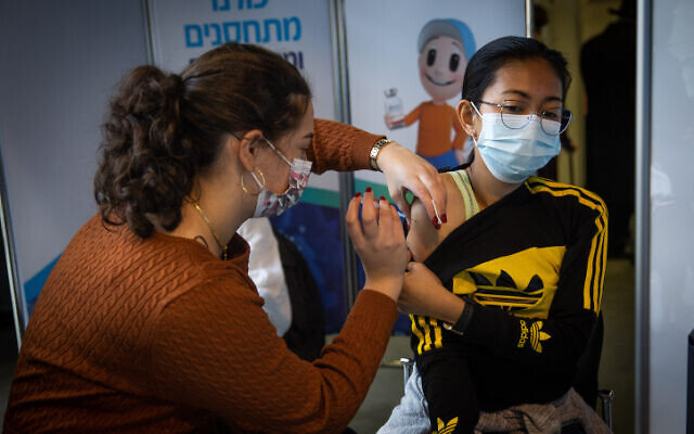 A woman receives a COVID-19 vaccine in Jerusalem on December 28, 2020. (Yonatan Sindel/Flash90) A woman receives a COVID-19 vaccine in Jerusalem on December 28, 2020. (Yonatan Sindel/Flash90)