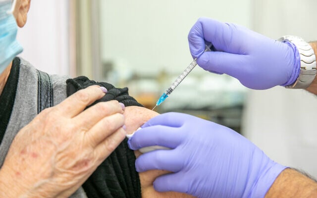 Illustrative: A man receives a COVID-19 vaccine at a vaccination center in Kaplan Medical Center in Rehovot, December 29, 2020. (Yossi Aloni/Flash90) Illustrative: A man receives a COVID-19 vaccine at a vaccination center in Kaplan Medical Center in Rehovot, December 29, 2020. (Yossi Aloni/Flash90)