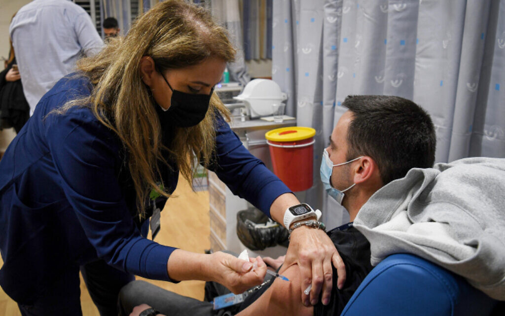 An Israeli teacher receives a COVID-19 vaccine, at the Shamir Medical Center in Be'er Ya'akov, on December 30, 2020. (Avi Dishi/Flash90) An Israeli teacher receives a COVID-19 vaccine, at the Shamir Medical Center in Be'er Ya'akov, on December 30, 2020. (Avi Dishi/Flash90)