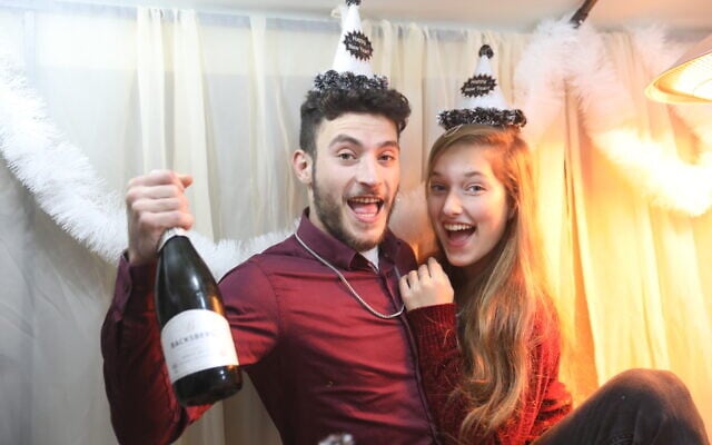 An Israeli couple celebrates New Year's Eve, in central Israel, December 31, 2020. (Yossi Aloni/FLASH90) An Israeli couple celebrates New Year's Eve, in central Israel, December 31, 2020. (Yossi Aloni/FLASH90)