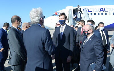 A joint Israel-US delegation, led by Meir Ben-Shabbat (right) and Jared Kushner (center) is greeted on landing in Rabat, after the first direct flight between Israel and Morocco, December 22, 2020 (Amos Ben-Gershom/GPO)