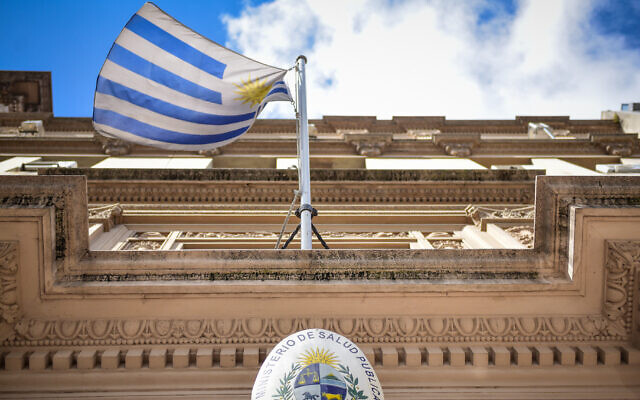 Uruguayan flag flies in front of the entrance to the Ministry of Public Health as precautions are taken against COVID-19 in Montevideo, Uruguay on March 16, 2020. (Carlos Lebrato/Anadolu Agency/Getty Images via JTA) Uruguayan flag flies in front of the entrance to the Ministry of Public Health as precautions are taken against COVID-19 in Montevideo, Uruguay on March 16, 2020. (Carlos Lebrato/Anadolu Agency/Getty Images via JTA)