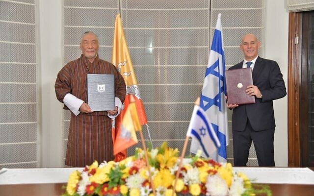 Israel's ambassador to India, Ron Malka, right, signs a deal with his counterpart, Ambassador of Bhutan to India Major General Vetsop Namgyel establishing diplomatic relations with Israel, at Malka's residence in India, December 12, 2020. (Israel Ministry of Foreign Affairs) Israel's ambassador to India, Ron Malka, right, signs a deal with his counterpart, Ambassador of Bhutan to India Major General Vetsop Namgyel establishing diplomatic relations with Israel, at Malka's residence in India, December 12, 2020. (Israel Ministry of Foreign Affairs)