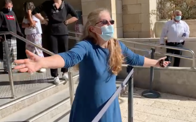 A resident of the Dan Panorama hotel in Jerusalem, which is being run by the military as a quarantine facility, protesting conditions, December 21, 2020 (screen shot) A resident of the Dan Panorama hotel in Jerusalem, which is being run by the military as a quarantine facility, protesting conditions, December 21, 2020 (screen shot)