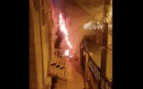 A screen capture of video from social media shows a Christmas tree that was set on fire outside a church in the northern Arab Israeli city of Sakhnin, December 30, 2020. (Screen capture: Twitter)
