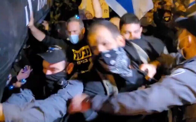 Anti-Netanyahu protesters scuffle with police during a demonstration in the northern town of Binyamina, on December 31, 2020. (Screen capture: Twitter) Anti-Netanyahu protesters scuffle with police during a demonstration in the northern town of Binyamina, on December 31, 2020. (Screen capture: Twitter)