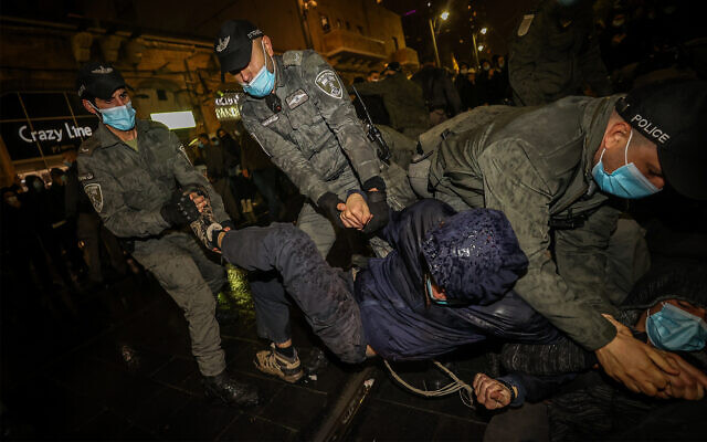 Israeli police scuffle with demonstrators during a protest over a young settler who was killed earlier this week in a car crash during a police chase after allegedly throwing stones at Palestinians, Jerusalem, December 23, 2020. (Yonatan Sindel/Flash90) Israeli police scuffle with demonstrators during a protest over a young settler who was killed earlier this week in a car crash during a police chase after allegedly throwing stones at Palestinians, Jerusalem, December 23, 2020. (Yonatan Sindel/Flash90)