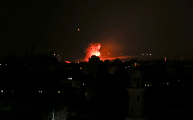 Smoke and flames are seen following an Israeli airstrike in Gaza City, which came after terrorists in the Strip fired rockets into Israel, December 26, 2020. (Mahmud Hams/AFP) Smoke and flames are seen following an Israeli airstrike in Gaza City, which came after terrorists in the Strip fired rockets into Israel, December 26, 2020. (Mahmud Hams/AFP)