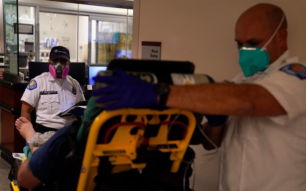 Emergency medical technicians wait for a bed to be cleared in an emergency room in Mission Viejo, California, December 21, 2020. (AP Photo/Jae C. Hong) Emergency medical technicians wait for a bed to be cleared in an emergency room in Mission Viejo, California, December 21, 2020. (AP Photo/Jae C. Hong)