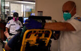 Emergency medical technicians wait for a bed to be cleared in an emergency room in Mission Viejo, California, December 21, 2020. (AP Photo/Jae C. Hong)