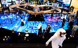 People visit an exhibit at the GITEX technology summit in Dubai, United Arab Emirates, Dec. 7, 2020. (AP Photo/Jon Gambrell)