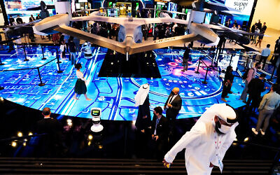 People visit an exhibit at the GITEX technology summit in Dubai, United Arab Emirates, Dec. 7, 2020. (AP Photo/Jon Gambrell)