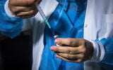 A nurse prepares a vial of coronavirus vaccine in Jerusalem, December 29, 2020. (Olivier Fitoussi/Flash90)