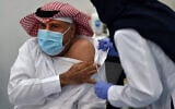 The first Saudi citizen to receive the Pfizer-BioNTech COVID-19 vaccine prepares for the shot in Riyadh, Saudi Arabia. (Fayez Nureldine/AFP)