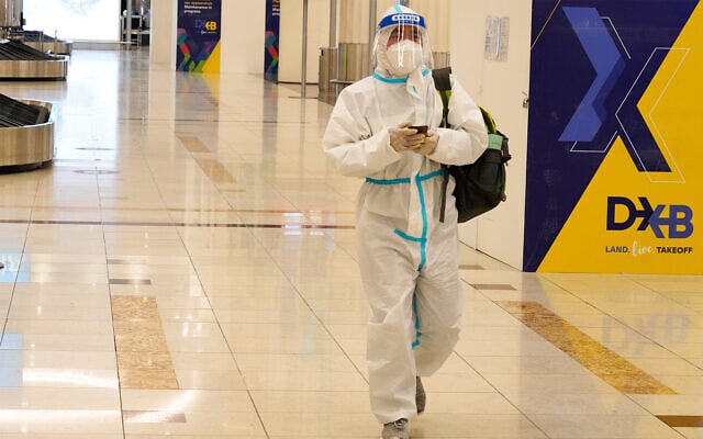 A passenger in a full, disposable hazmat suit arrives at the baggage claim area of Dubai International Airport's Terminal 3 in Dubai, United Arab Emirates, Nov. 26, 2020. (AP Photo/Jon Gambrell) A passenger in a full, disposable hazmat suit arrives at the baggage claim area of Dubai International Airport's Terminal 3 in Dubai, United Arab Emirates, Nov. 26, 2020. (AP Photo/Jon Gambrell)