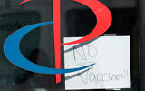 A sign on the entrance to a Parcare health care facility announces that they have "No Vaccines!!" in the Williamsburg section of Brooklyn, New York, December 27, 2020. (AP Photo/Kathy Willens)