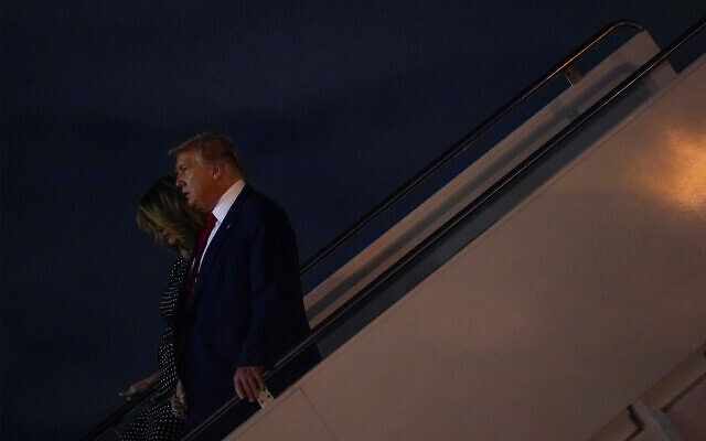 US President Donald Trump and first lady Melania Trump step off Air Force One at Palm Beach International Airport in Florida, December 23, 2020. (AP Photo/Patrick Semansky) US President Donald Trump and first lady Melania Trump step off Air Force One at Palm Beach International Airport in Florida, December 23, 2020. (AP Photo/Patrick Semansky)