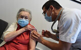 A resident of a retirement receives a dose of the Pfizer/BioNtech COVID-19 vaccine, in Loos, northern France, on December 28, 2020. (Francois Lo Presti/AFP)