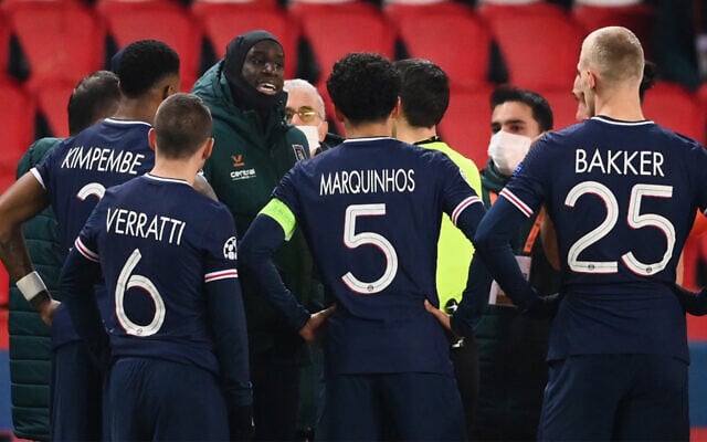 Istanbul Basaksehir's French forward Demba Ba (L) talks to a referee after a game was suspended amid allegations of racism by one of the match officials during a UEFA Champions League game between Paris Saint-Germain (PSG) and Istanbul Basaksehir FK in Paris, December 8, 2020. (Franck Fife/AFP) Istanbul Basaksehir's French forward Demba Ba (L) talks to a referee after a game was suspended amid allegations of racism by one of the match officials during a UEFA Champions League game between Paris Saint-Germain (PSG) and Istanbul Basaksehir FK in Paris, December 8, 2020. (Franck Fife/AFP)