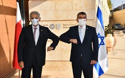Foreign Minister Gabi Ashkenazi greets Bahraini Industry, Commerce and Tourism Minister Zayed R. Alzayani in Jerusalem on December 2, 2020 (Shlomi Amsalem/GPO)