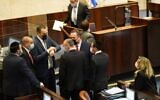 Coalition MKs watch the final moments of the 23rd Knesset tick away in the Knesset plenum on December 23, 2020. (Knesset spokesperson)