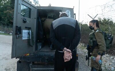 A photo released by the Israel Defense Forces on December 24, 2020, shows soldiers in the West Bank detaining a suspect in the suspected murder of Israeli woman Esther Horgen. (Israel Defense Forces)