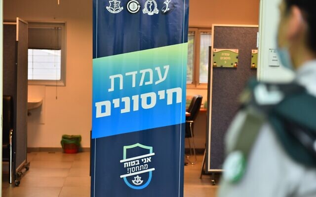 An officer stands in front of a vaccination center at Military Intelligence's Gelilot Base north of Tel Aviv in an undated photograph. (Israel Defense Forces) An officer stands in front of a vaccination center at Military Intelligence's Gelilot Base north of Tel Aviv in an undated photograph. (Israel Defense Forces)