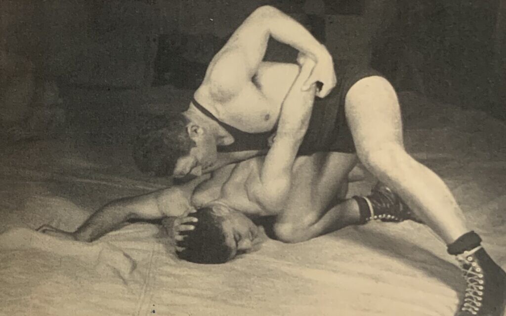 Zalman Unreich (On) teaching wrestling in Palestine, 1930s. Photo appeared on collecting cards and in book titled, 'Mishmar VeSport' (https://www.nli.org.il/he/books/NNL_ALEPH002015431/NLI)