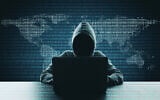 Illustrative: Hacker using laptop on abstract binary code map background. (Peshkov/ iStock, by Getty Images)