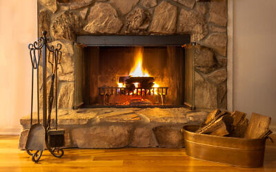 Illustrative: A fire burns in a stone fireplace (Carol A Hudson; iStock by Getty Images)