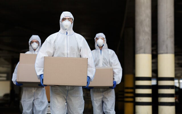 Illustrative: Couriers in protective clothing deliver vaccine supplies (Prostock-Studio via iStock by Getty Images) Illustrative: Couriers in protective clothing deliver vaccine supplies (Prostock-Studio via iStock by Getty Images)