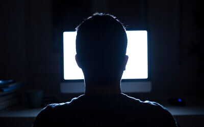 Illustrative: Silhouette of a man's head in front of a computer monitor (tommaso79; iStock by Getty Images)