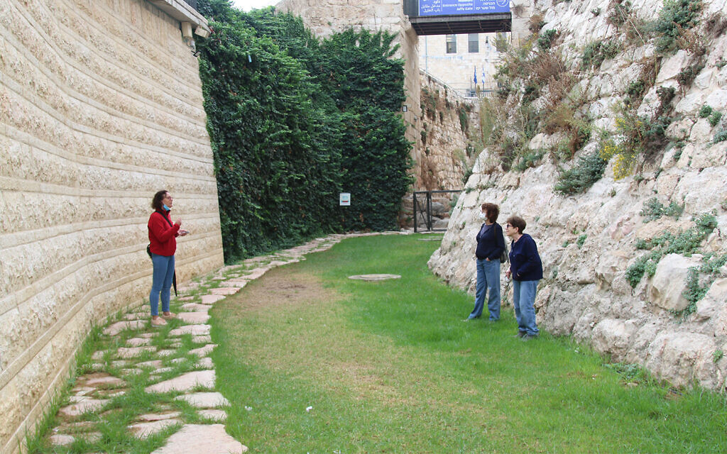 Visitors to Jerusalem's Old City in the dry moat that surrounds the Crusader-era citadel in the Tower of David Museum. Castle moats in Europe were filled with water, but Jerusalem's was left dry, due to lack of water. (Shmuel Bar-Am)