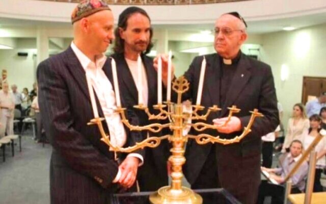 Pope Francis (far right) lights candles at a 2012 Hanukkah Interfaith Celebration at a Buenos Aires synagogue with current World Union of Progressive Judaism head Rabbi Sergio Bergman. (courtesy)