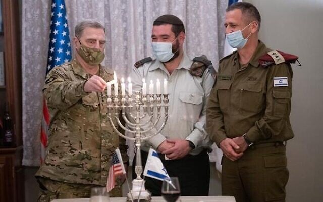 US Chairman of the Joint Chiefs of Staff Gen. Mark Milley lights a menorah on the eighth night of the Hannukah holiday alongside Cpt. Josh Gerstein and IDF Chief of Staff Aviv Kohavi in army headquarters in Tel Aviv on December 17, 2020. (Israel Defense Forces) US Chairman of the Joint Chiefs of Staff Gen. Mark Milley lights a menorah on the eighth night of the Hannukah holiday alongside Cpt. Josh Gerstein and IDF Chief of Staff Aviv Kohavi in army headquarters in Tel Aviv on December 17, 2020. (Israel Defense Forces)