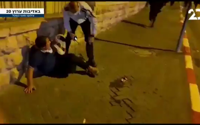Commander Shimon Marciano stands next to the young boy he shoved towards a wall during an ultra-Orthodox protest in Jerusalem on October 4, 2020 (Screenshot: Twitter) Commander Shimon Marciano stands next to the young boy he shoved towards a wall during an ultra-Orthodox protest in Jerusalem on October 4, 2020 (Screenshot: Twitter)