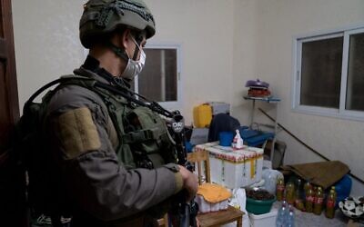 A photo released by the Israel Defense Forces on December 23, 2020, shows a soldier in the West Bank village of Qabatiya, during a raid of the home of Ahmad Abu al-Rabb. (Israel Defense Forces)