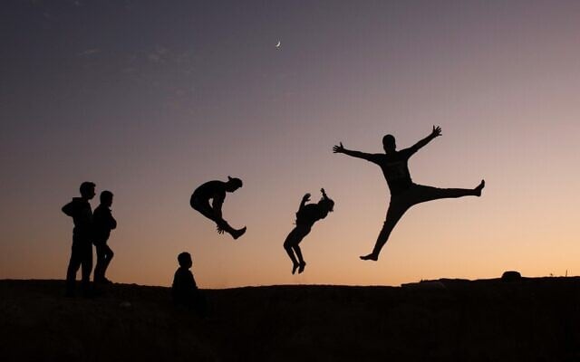 Palestinian youths practice parkour in Gaza City, on November 18, 2020. (MOHAMMED ABED/AFP)