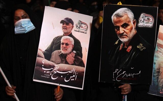 People carry portraits of late Iraqi commander Abu Mahdi al-Muhandis and Iranian commander Qasem Soleimani at Baghdad Airport, in Baghdad on January 2, 2021, at the site of their killing (AHMAD AL-RUBAYE / AFP) People carry portraits of late Iraqi commander Abu Mahdi al-Muhandis and Iranian commander Qasem Soleimani at Baghdad Airport, in Baghdad on January 2, 2021, at the site of their killing (AHMAD AL-RUBAYE / AFP)