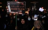 An Iraqi woman carries a poster at Baghdad Airport, in Baghdad on January 2, 2021, at the site of the killing of an Iraqi commander and the commander of the Iranian Revolutionary Guard (AHMAD AL-RUBAYE / AFP)