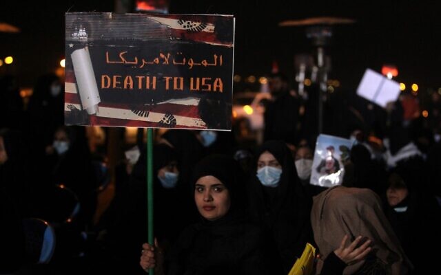 An Iraqi woman carries a poster at Baghdad Airport, in Baghdad on January 2, 2021, at the site of the killing of an Iraqi commander and the commander of the Iranian Revolutionary Guard (AHMAD AL-RUBAYE / AFP) An Iraqi woman carries a poster at Baghdad Airport, in Baghdad on January 2, 2021, at the site of the killing of an Iraqi commander and the commander of the Iranian Revolutionary Guard (AHMAD AL-RUBAYE / AFP)