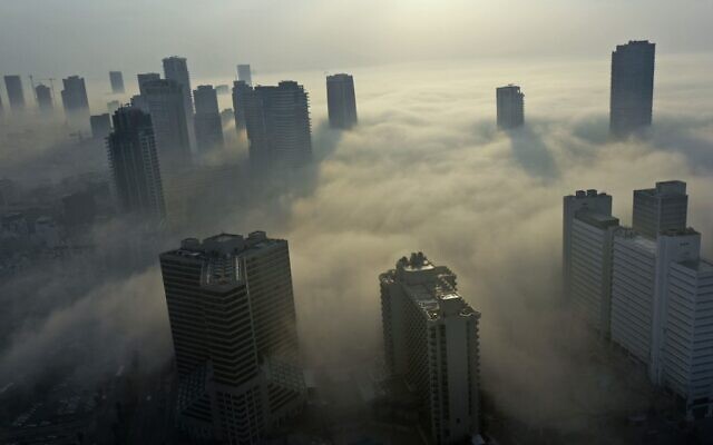Morning fog blankets the city of Tel Aviv on the Mediterranean seashore, on January 4, 2021. (MENAHEM KAHANA / AFP)