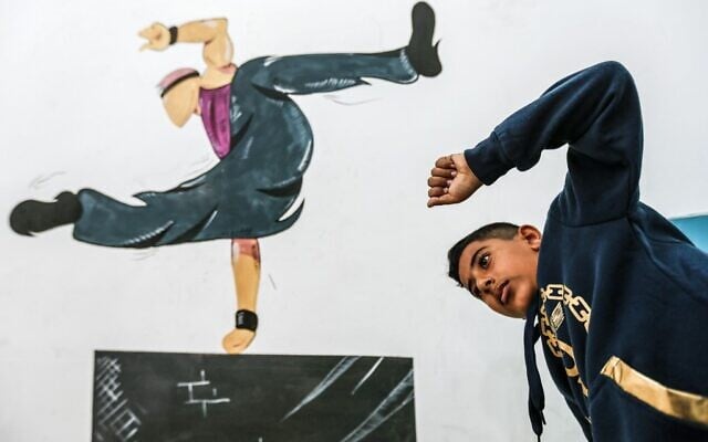 A Palestinian youth trains at the Wallrunners Parkour Academy's training facility in Gaza City on December 28, 2020.(MAHMUD HAMS / AFP)