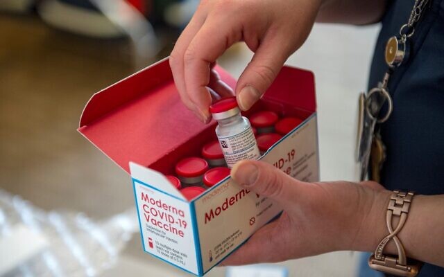 Illustrative: Courtney Senechal unpacks a special refrigerated box of Moderna COVID-19 vaccines as she prepared to ready more supply for use at the East Boston Neighborhood Health Center in Boston, Massachusetts, December 24, 2020. (Joseph Prezioso/AFP) Illustrative: Courtney Senechal unpacks a special refrigerated box of Moderna COVID-19 vaccines as she prepared to ready more supply for use at the East Boston Neighborhood Health Center in Boston, Massachusetts, December 24, 2020. (Joseph Prezioso/AFP)